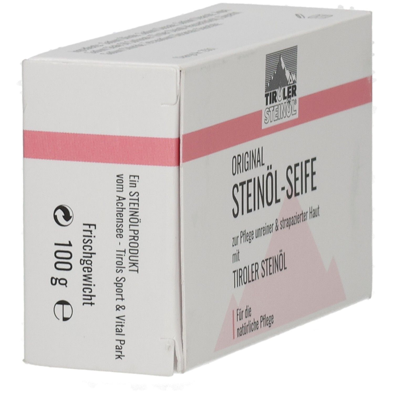 Kartonverpackung, weiß mit rosa Streifen. Aufschrift: ORIGINAL STEINÖL-SEIFE, TIROLER STEINÖL. 100 g Frischgewicht.