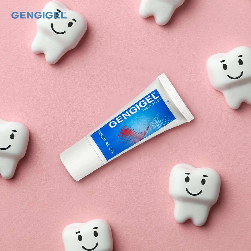 Gengigel® Gel Tube. Umgeben von Zahn-Emoticons. Rosa Hintergrund.
