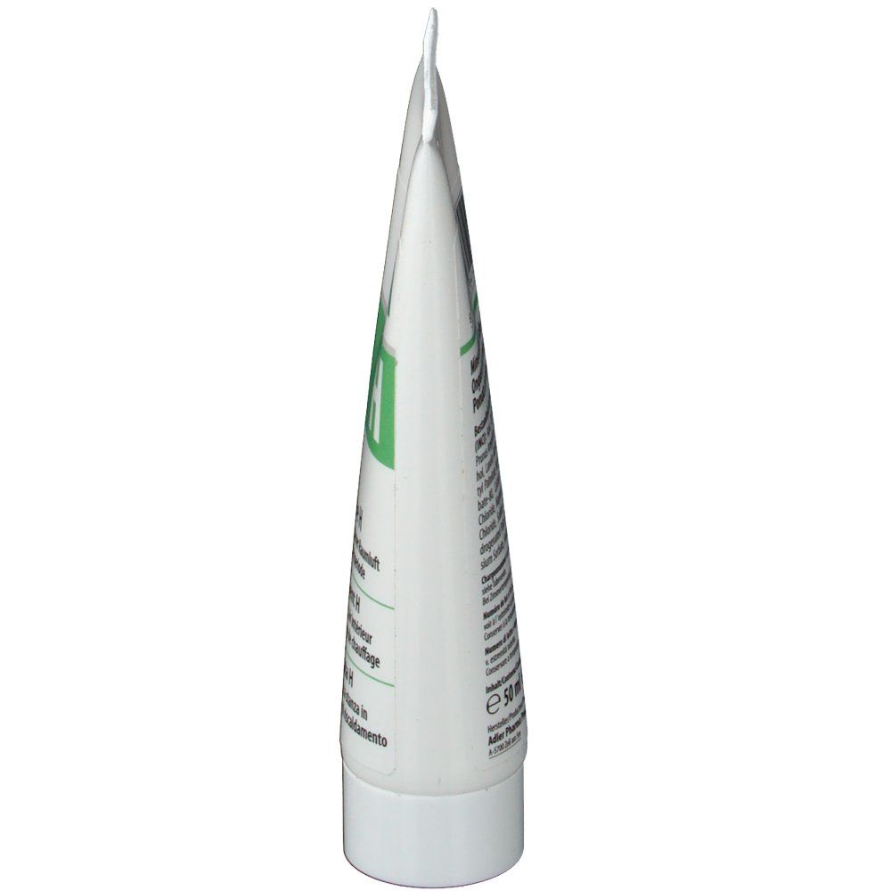 Seitenansicht einer weißen Tube. Grüne Schrift und Text auf der Tube.