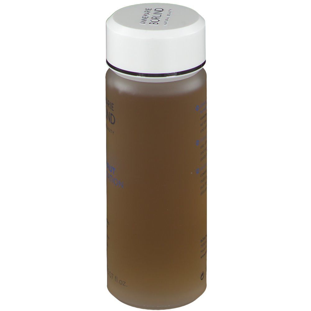 Zylindrische Flasche mit weißem Deckel. Aufschrift: ANNEMARIE BÖRLIND. Mischhaut Combination Skin. Braune Flüssigkeit.