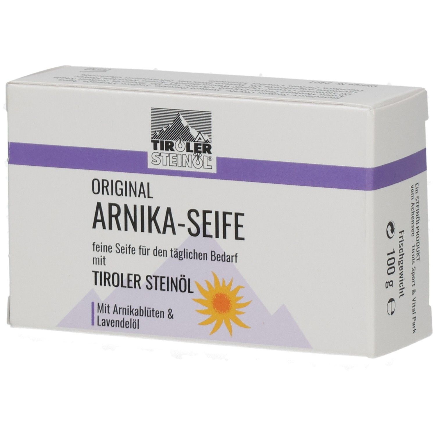Weißer Karton mit lila Streifen. Aufschrift: ORIGINAL ARNIKA-SEIFE, TIROLER STEINOEL. Mit Arnikablüten & Lavendelöl.
