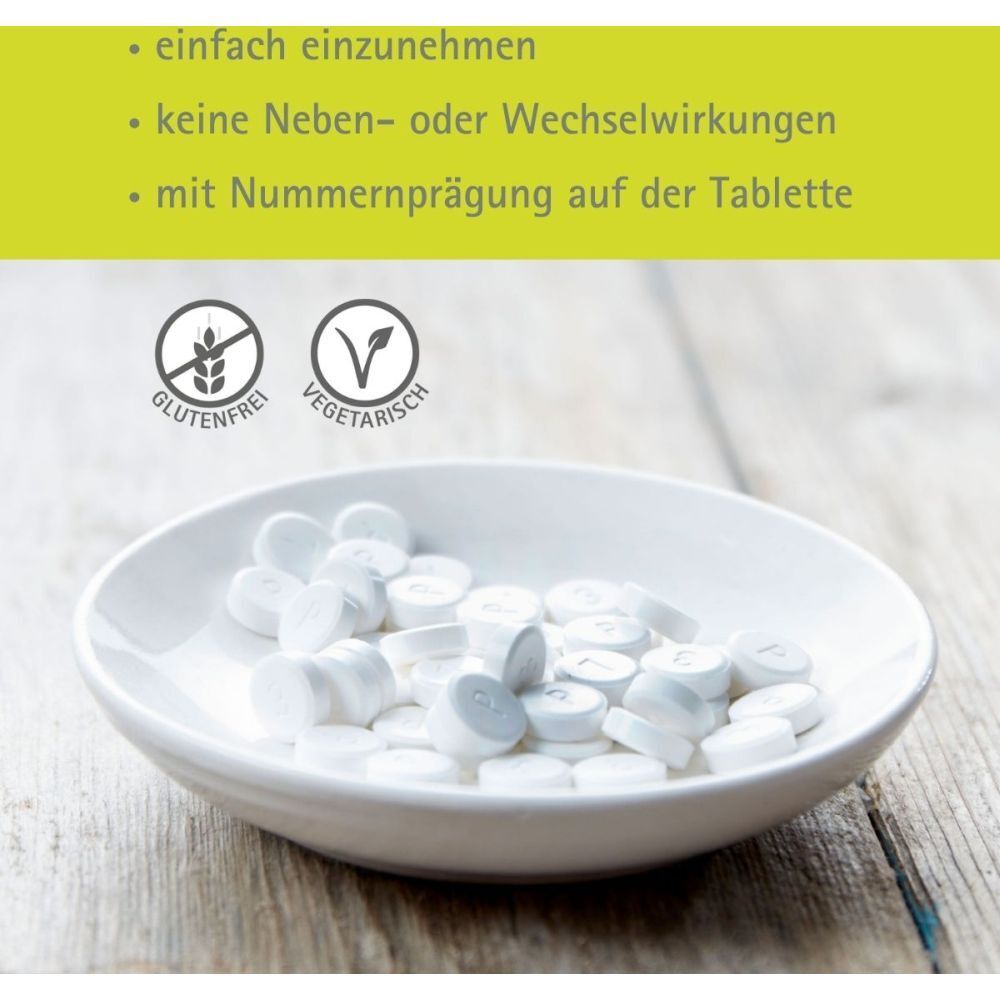 Weiße Tabletten in einer Schale. Text: glutenfrei, vegetarisch. Text: mit Nummernprägung auf der Tablette.