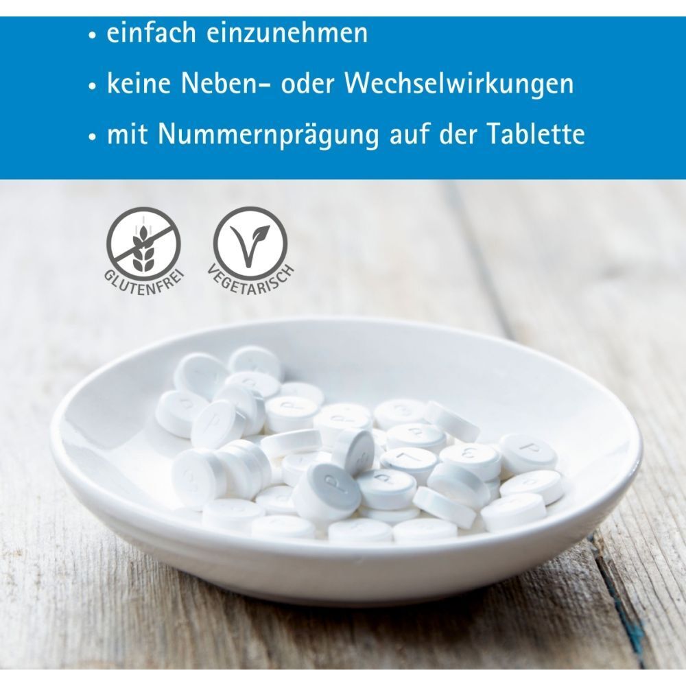 Weiße Tabletten in Schale. Text: glutenfrei, vegetarisch. Aufschrift auf Tablette.