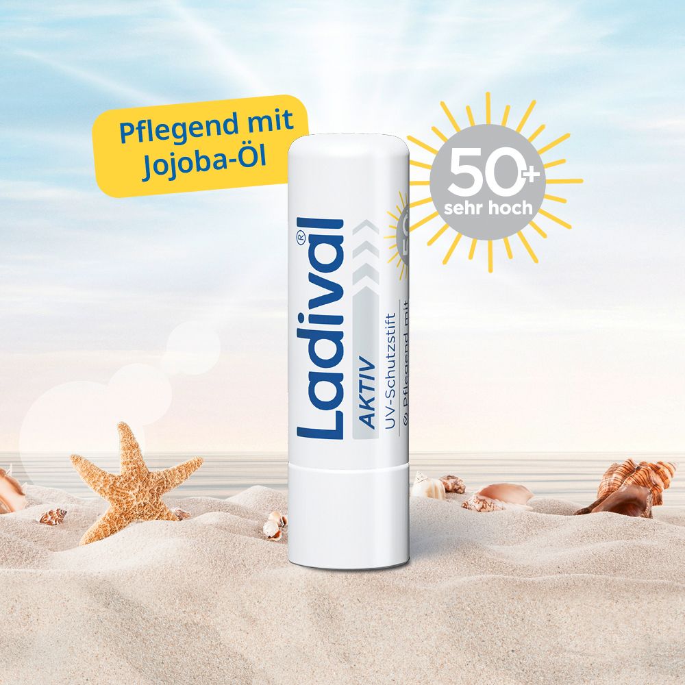 Weißer Lippenpflegestift mit Ladival-Logo und Text. Gelber Aufkleber: Pflegend mit Jojoba-Öl. 50+.