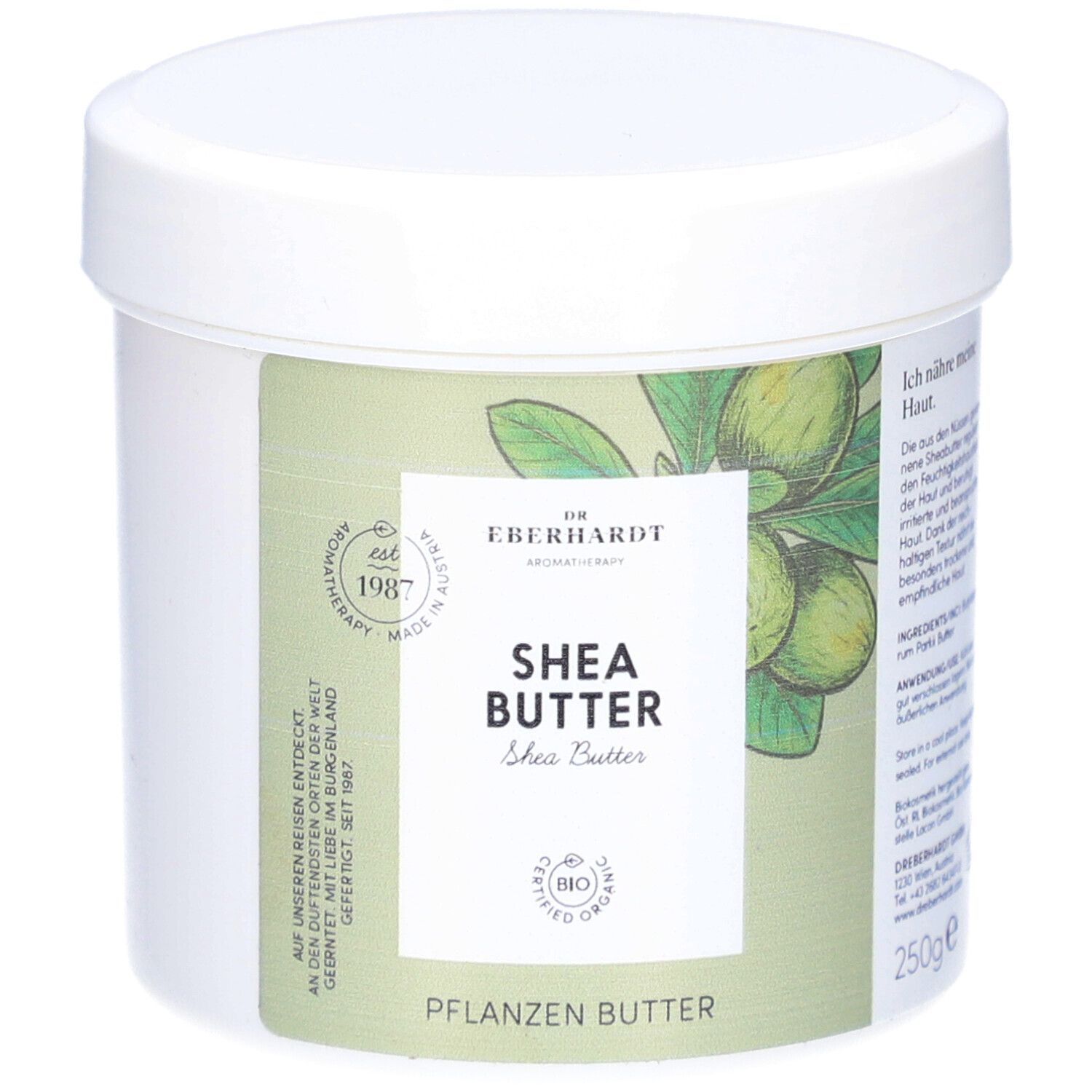 Weißer Tiegel mit Deckel. Aufkleber mit Produktnamen und Logo. Aufschrift: Shea Butter, Pflanzenbutter. Bio-Zertifizierung.