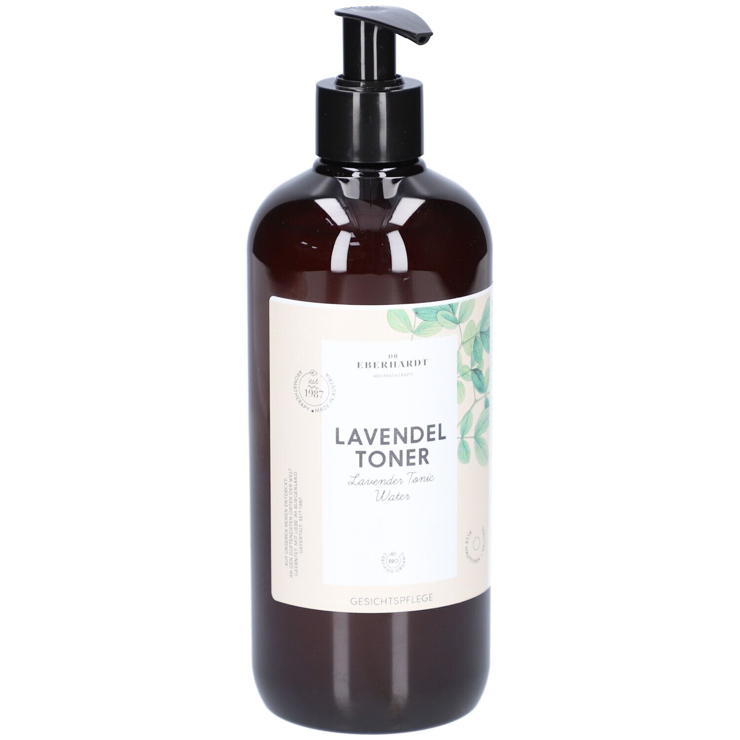 Braune Flasche mit schwarzem Pumpkopf. Aufschrift: LAVENDEL TONER. Mit grünen Blättern dekoriert.