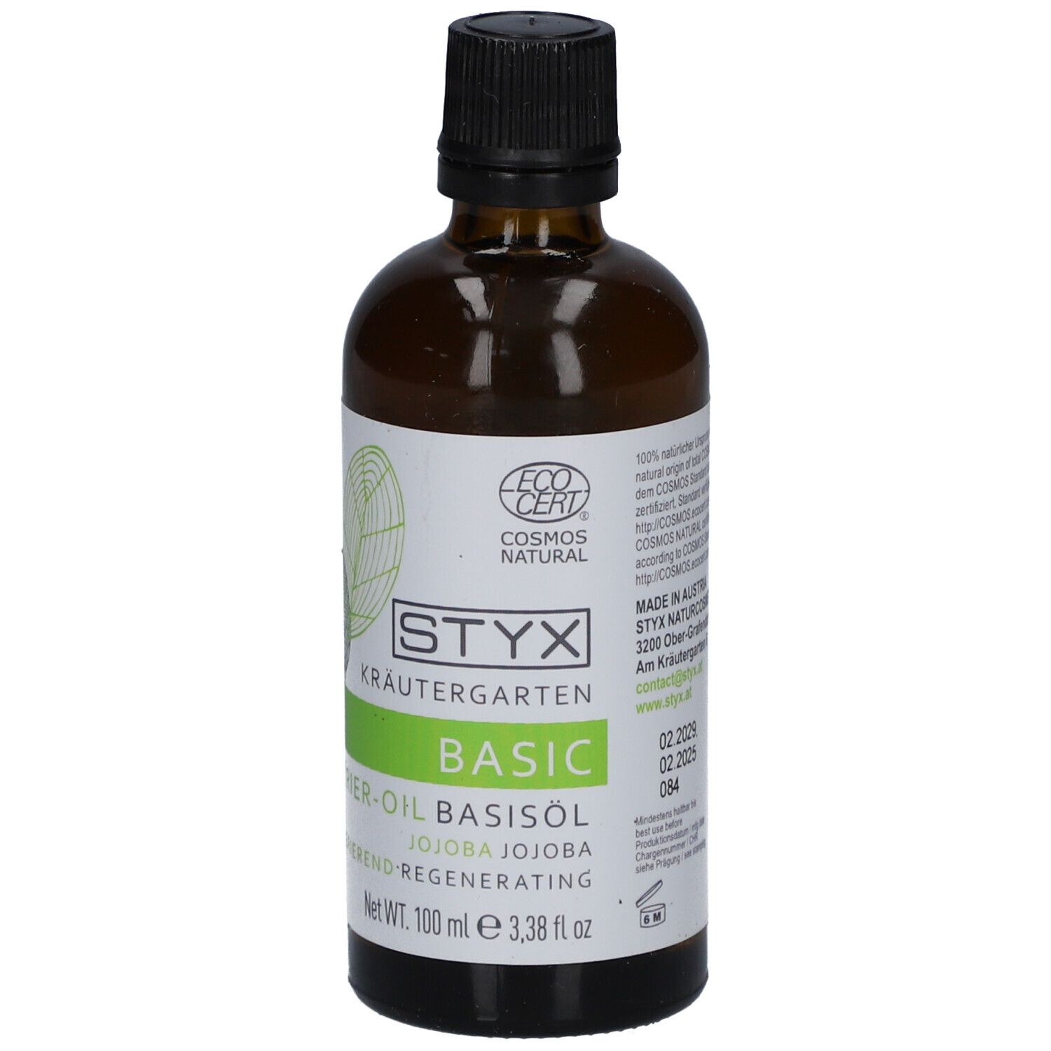 Braune Glasflasche mit schwarzem Deckel. Etikett mit STYX Kräutergarten, BASIC, Jojoba-Öl und Cosmos Natural-Zertifizierung.