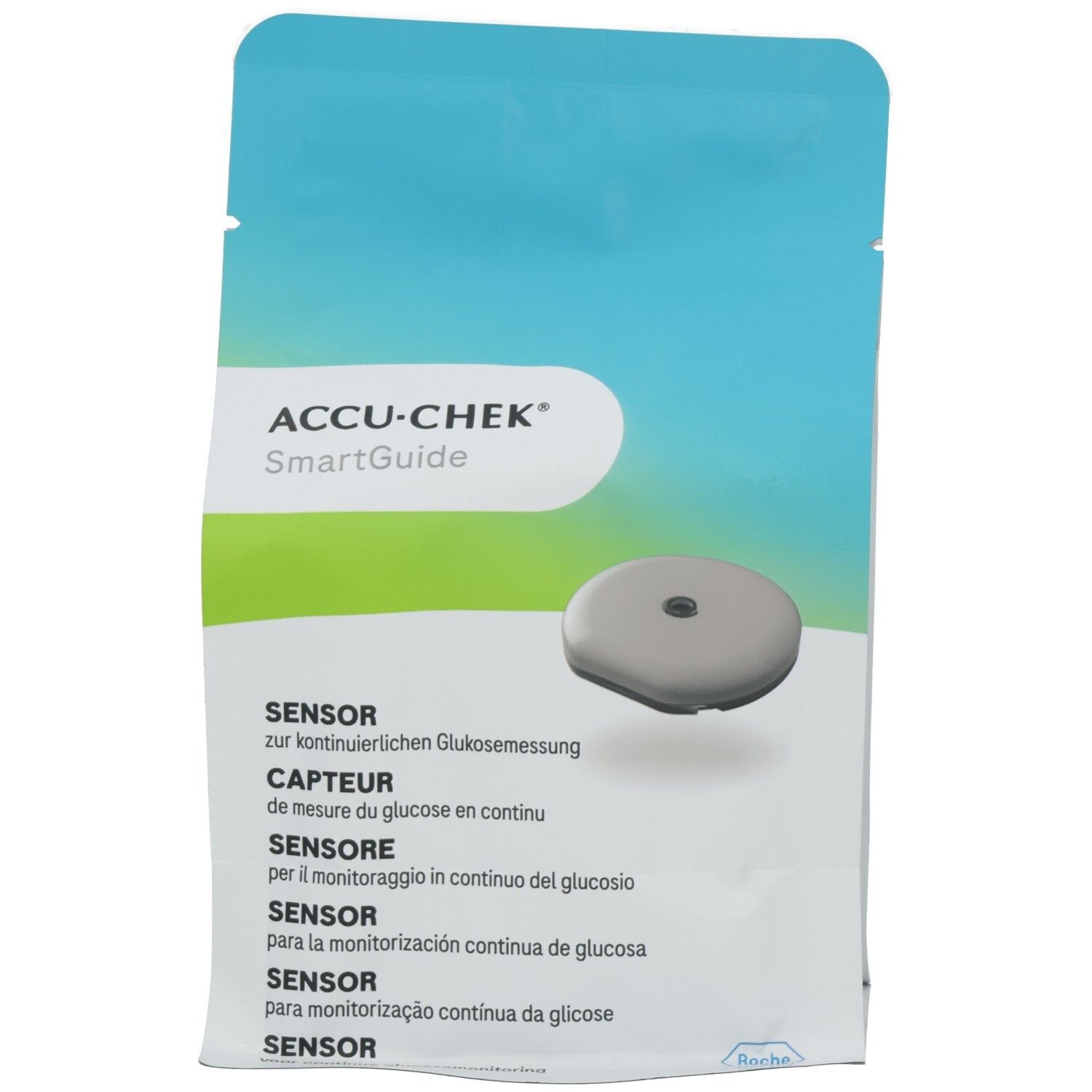 Verpackung mit ACCU-CHEK SmartGuide Sensor. Grauer Sensor, rund, mit zentraler Öffnung. Mehrsprachiger Text.