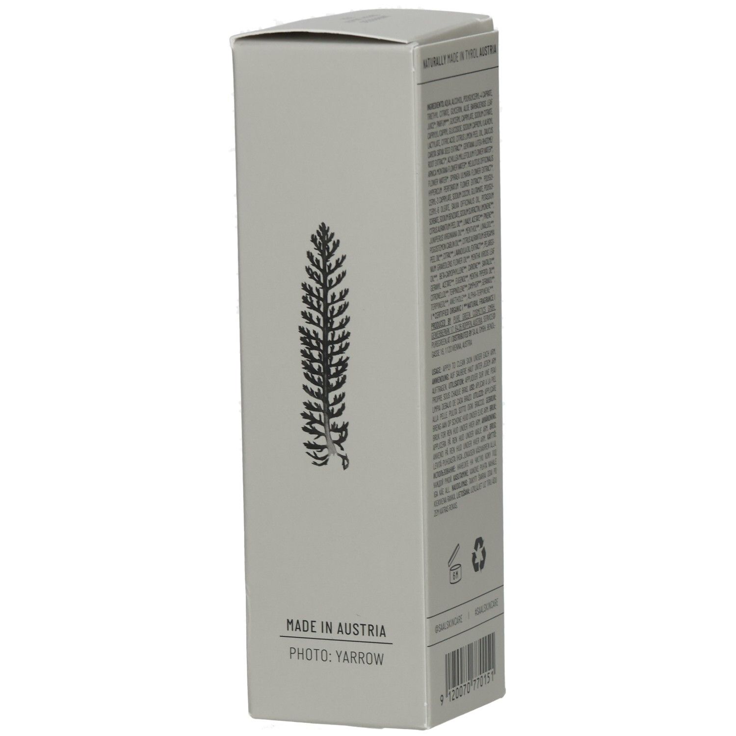 Graue Schachtel mit einem Pflanzen-Design. Hergestellt in Österreich. Foto: Yarrow. Barcode und Recycling-Symbole.