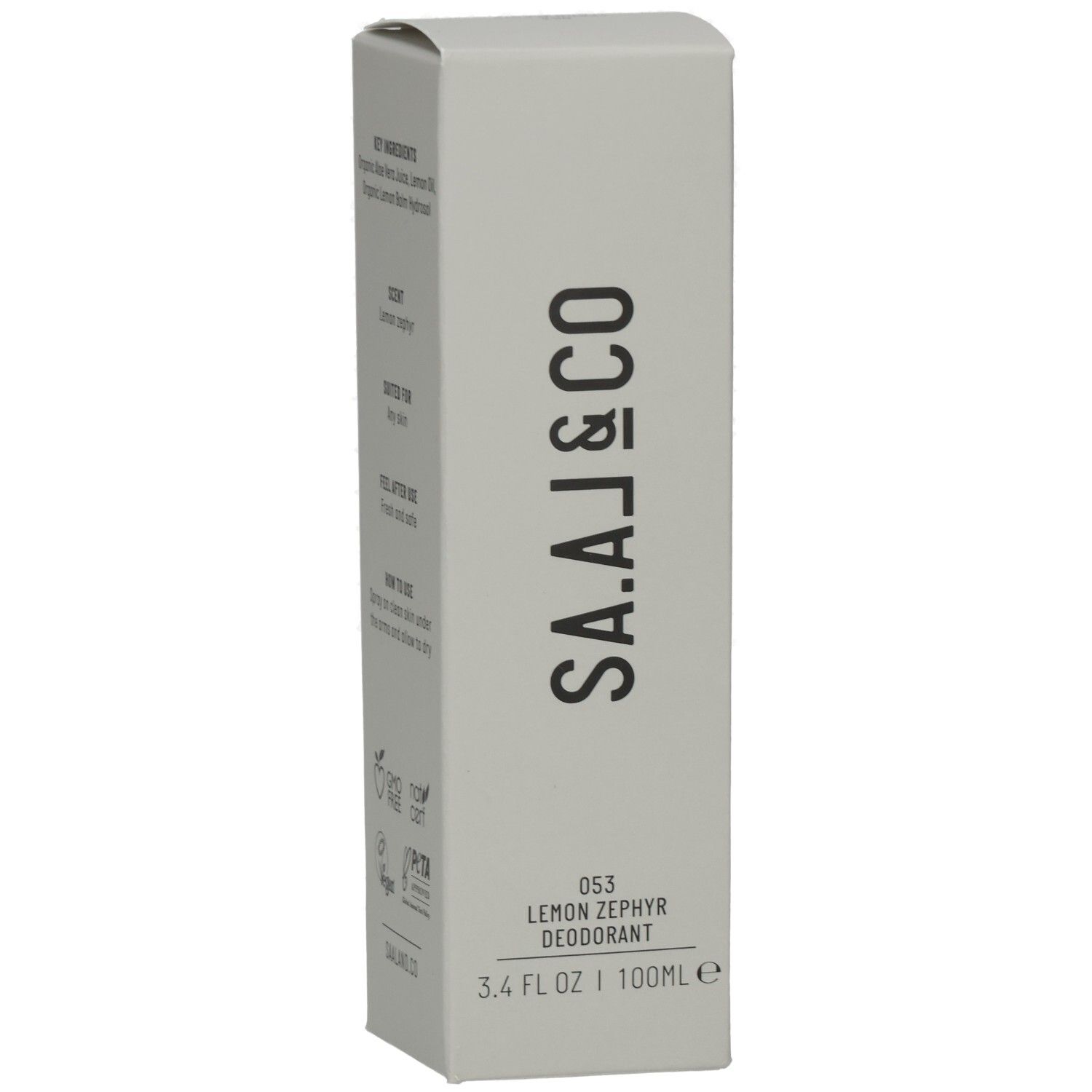 Graue Verpackung mit Text: Key Ingredients, Scent, Suited for, Feel after use, How to use. Logos: GMO Free, Natrue, Vegan, PETA.