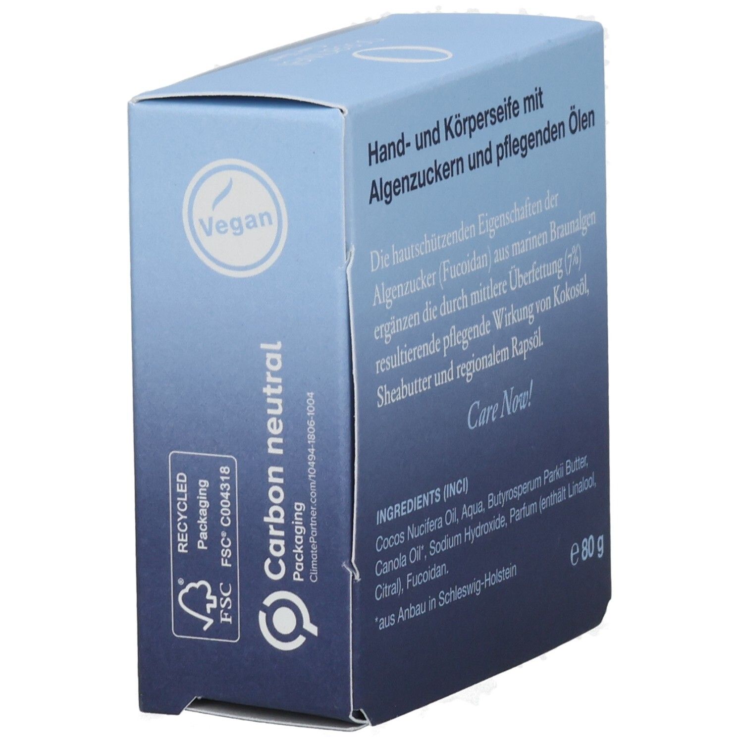 Hellblaue Schachtel. Text: Hand- und Körperseife mit Algenzucker. Vegan-Siegel. Carbon neutral.