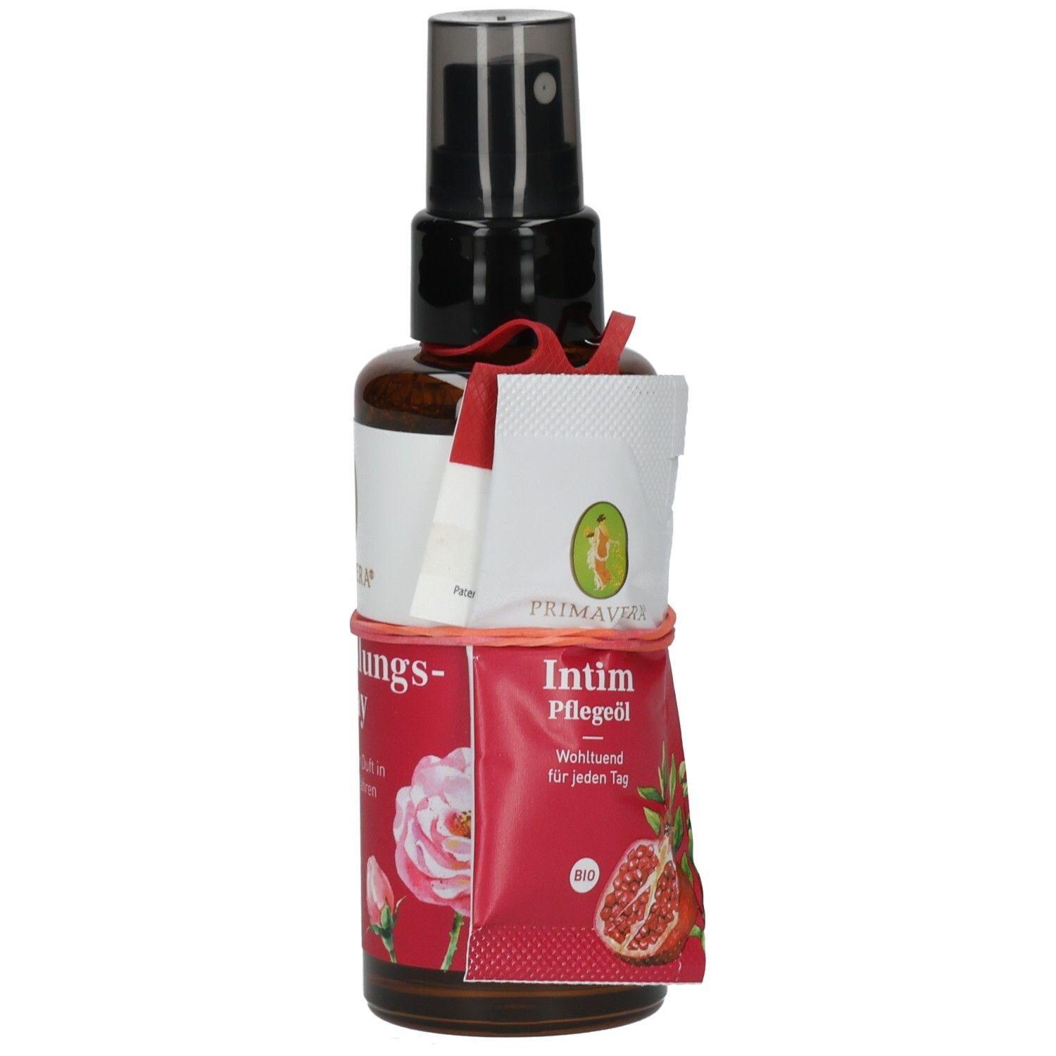 Braune Sprühflasche mit weißem Etikett und roter Banderole. Aufschrift: Intim Pflegeöl. Beilage mit Logo und Text.