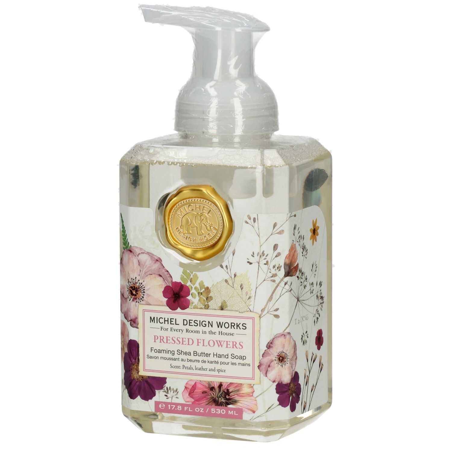 Klarer Seifenspender mit floralem Design und goldenem Siegel. Aufschrift: Pressed Flowers, Foaming Shea Butter Hand Soap.