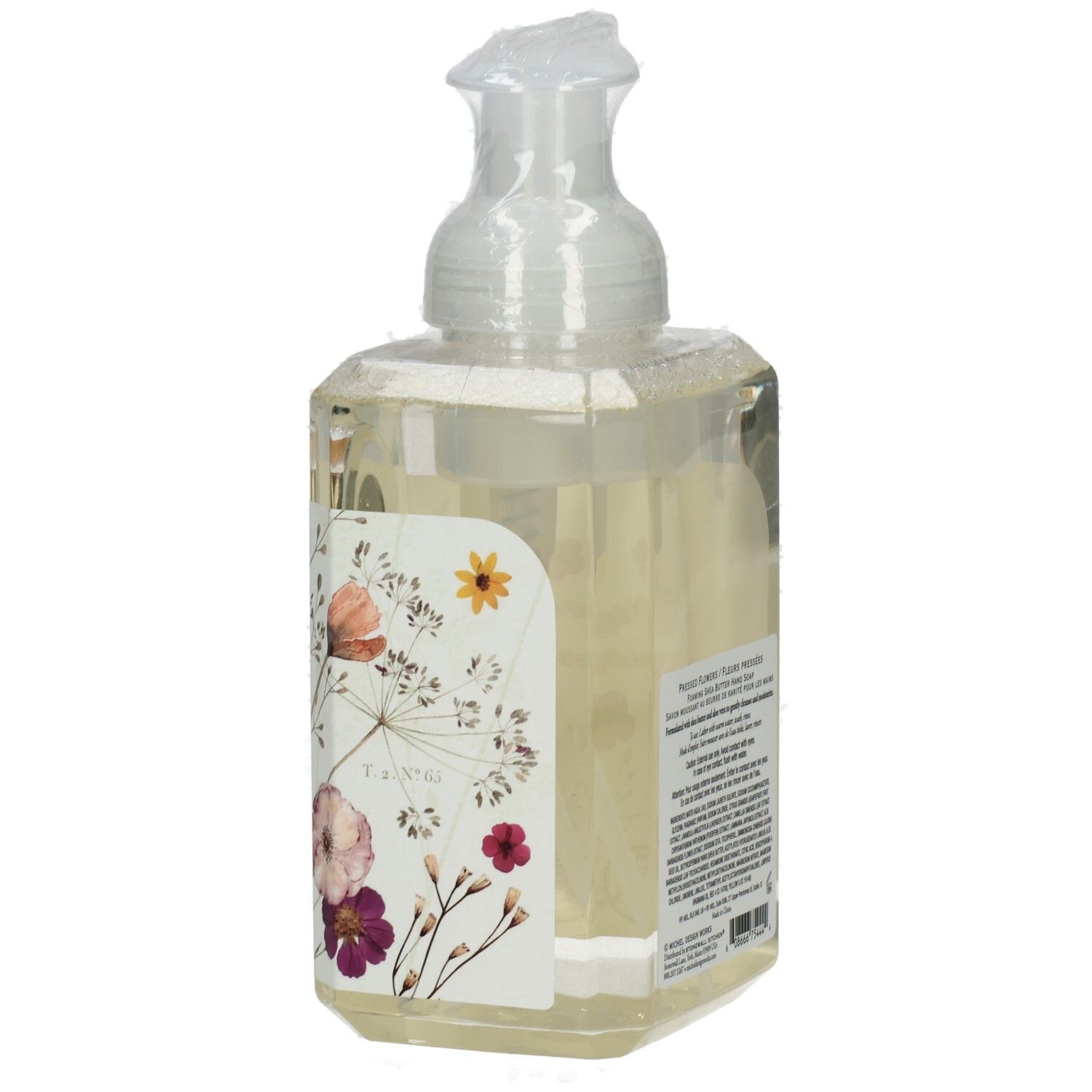 Seifenspender mit floralem Design. Aufschrift: Pressed Flowers. Sichtbare Marke: Michel Design Works.