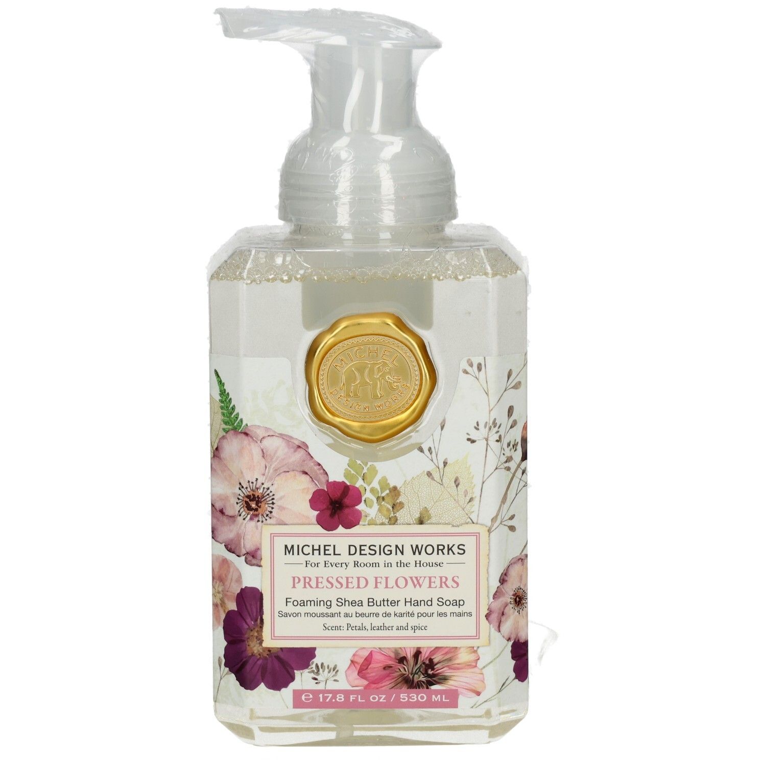 Klarer Seifenspender mit floralem Design und goldenem Siegel. Aufschrift: Pressed Flowers, Foaming Shea Butter Hand Soap.