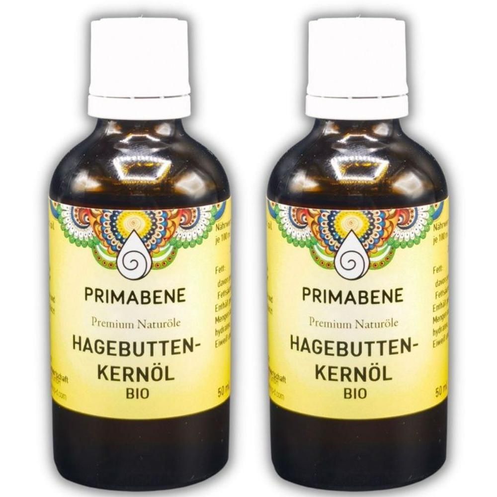 Zwei Flaschen PRIMABENE Hagebuttenkernöl BIO, braunes Glas, weiße Verschlüsse, gelbes Etikett mit Ornamenten.