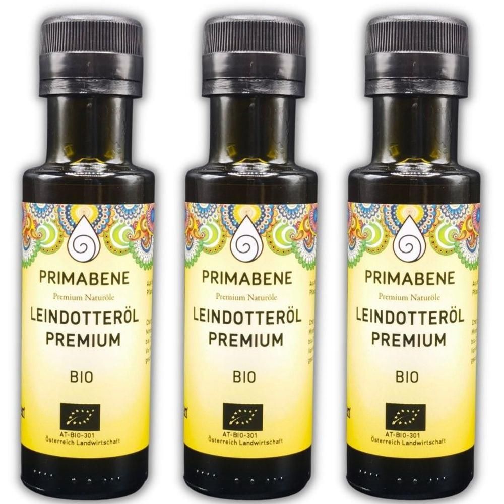 Drei Flaschen PRIMABENE Leindotteröl Premium BIO. Gelbes Etikett mit Ornamenten und Tropfensymbol.
