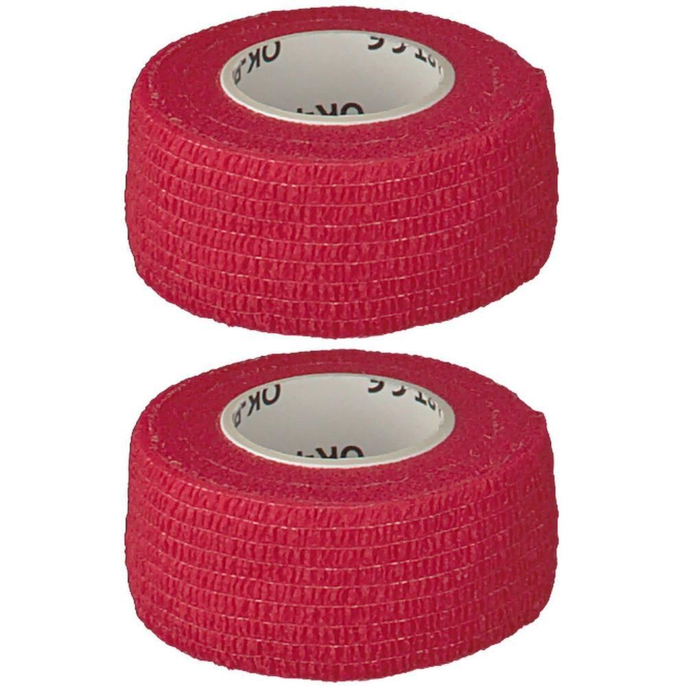 Zwei Rollen rotes, selbsthaftendes Verbandmaterial.