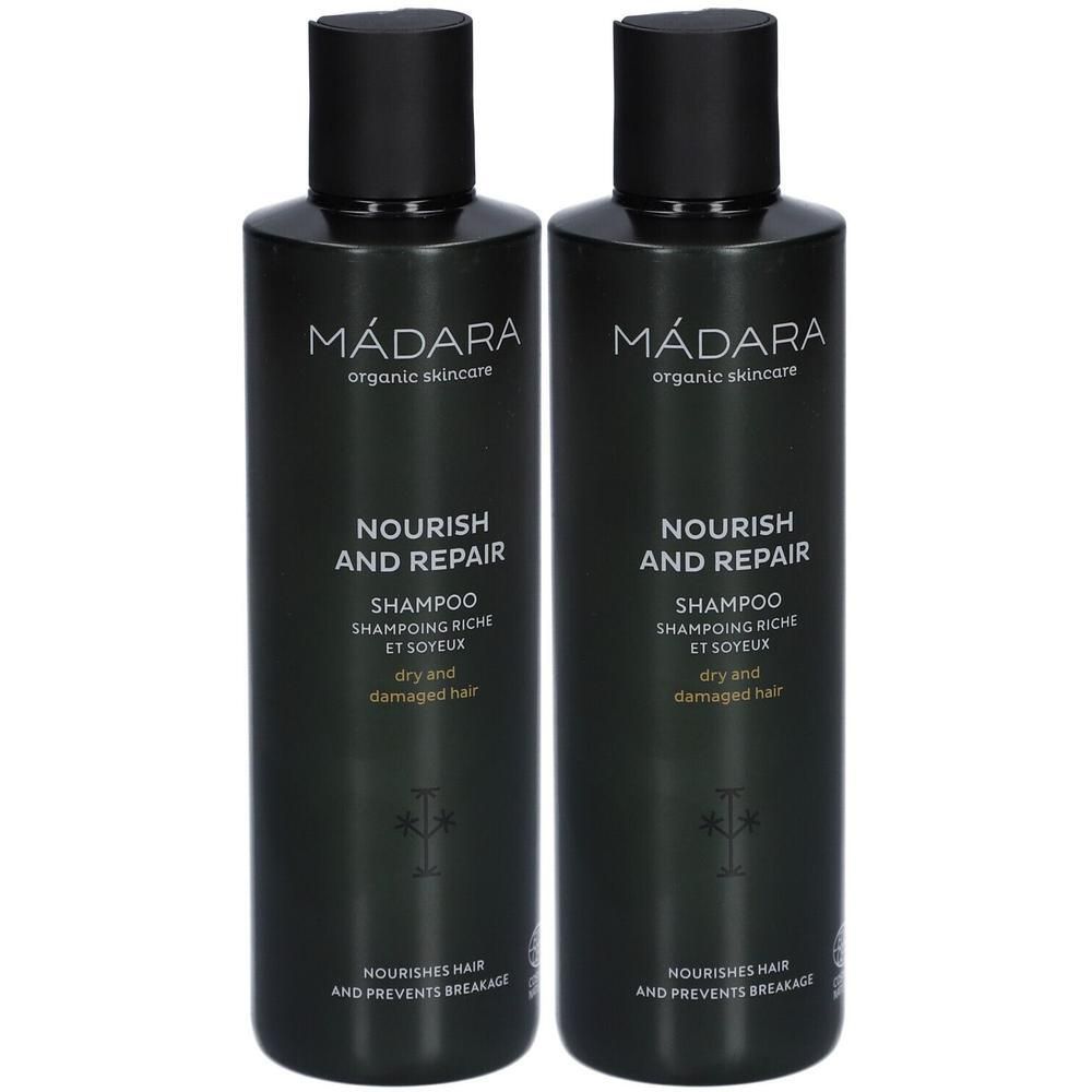 Zwei dunkle Flaschen MÁDARA Nourish and Repair Shampoo für trockenes, geschädigtes Haar.