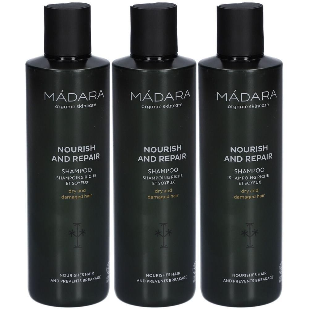Drei dunkle Flaschen MÁDARA Nourish and Repair Shampoo für trockenes und geschädigtes Haar.