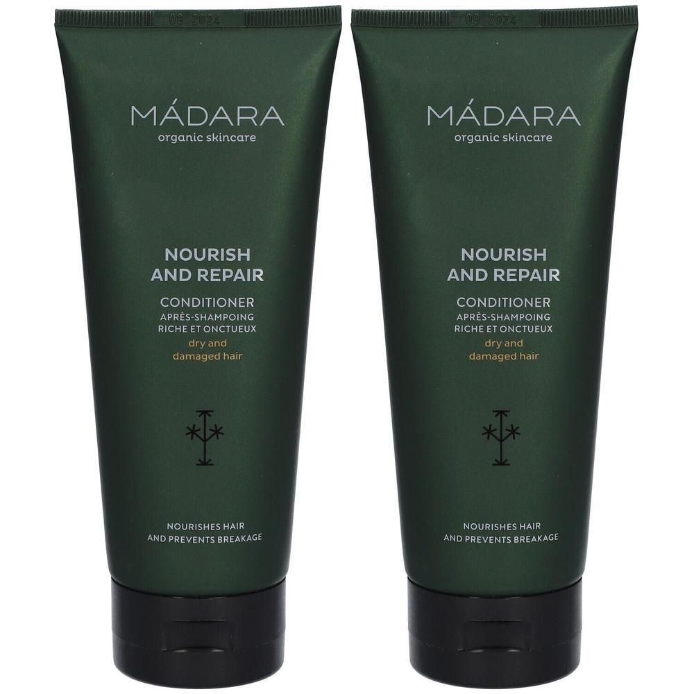Zwei grüne Tuben MÁDARA Nourish and Repair Conditioner für trockenes und geschädigtes Haar.