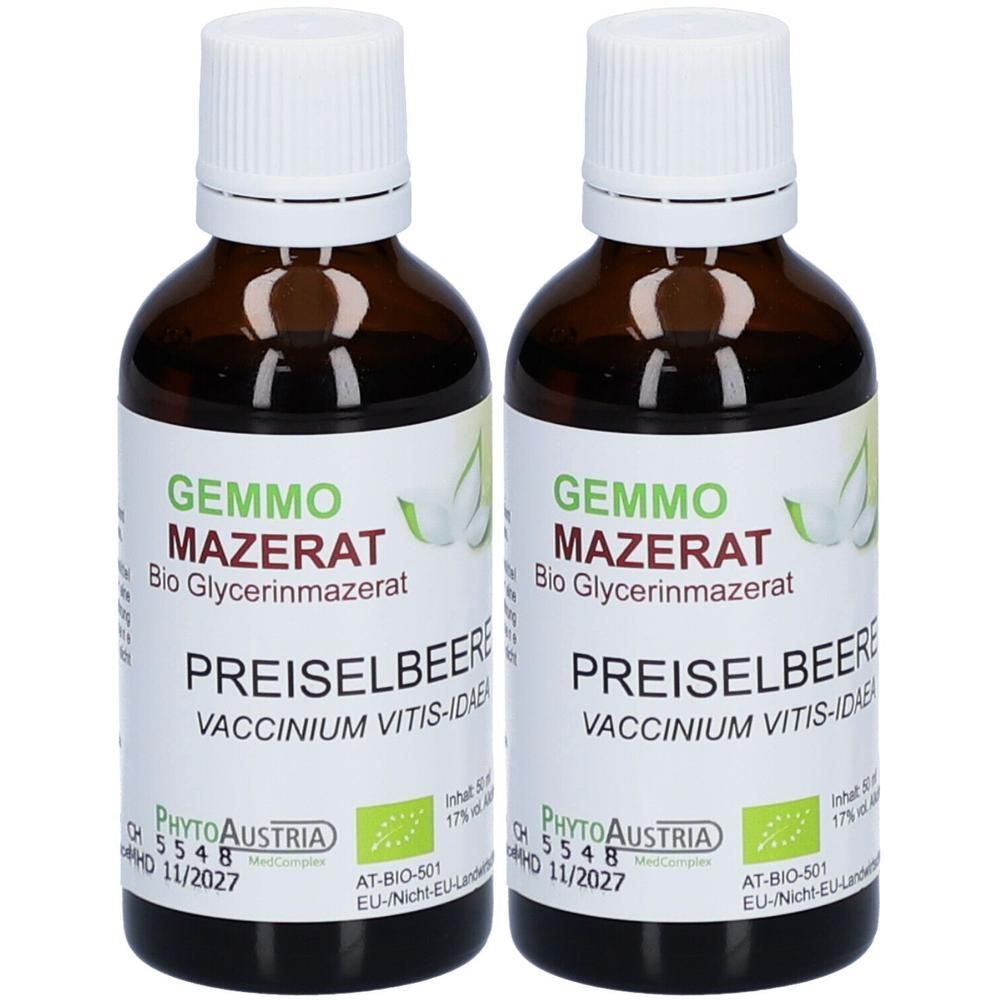 Zwei braune Glasflaschen mit weißen Verschlüssen, gefüllt mit flüssigem Produkt. Etiketten zeigen 'GEMMO MAZERAT Bio Glycerinmazerat PREISELBEERE'.