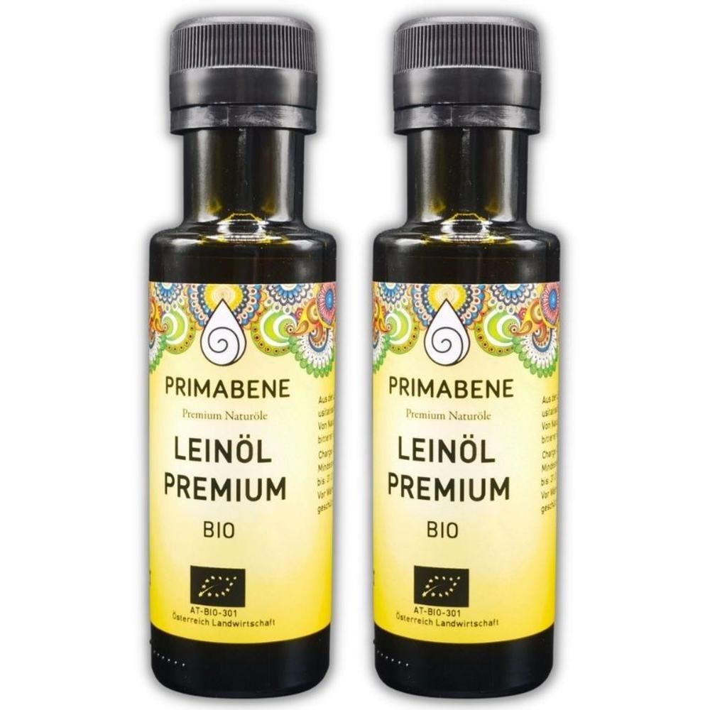 Zwei Flaschen PRIMABENE Leinöl Premium BIO mit schwarzem Schraubverschluss und gelbem Etikett mit bunten Verzierungen.