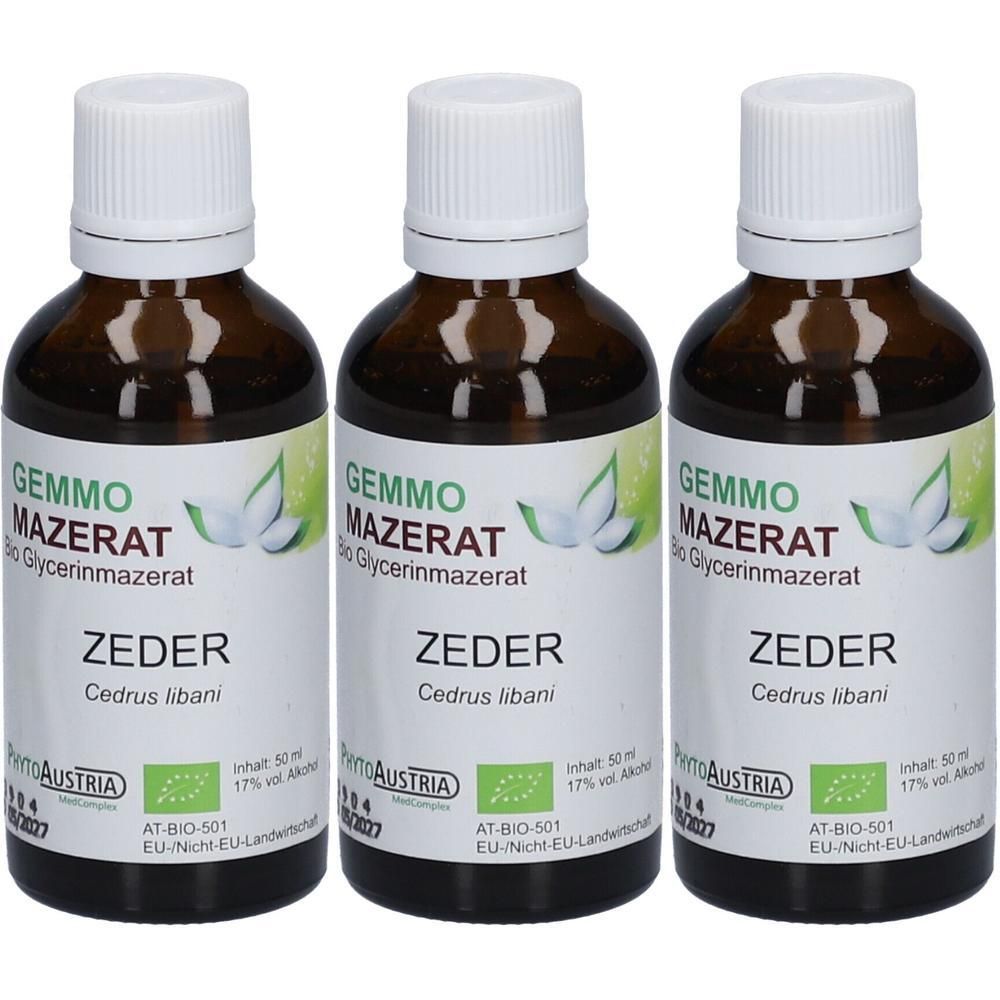 Drei braune Glasflaschen mit weißem Verschluss, gefüllt mit flüssigem Extrakt. Etikett mit 'GEMMO MAZERAT ZEDER' und Bio-Siegel.