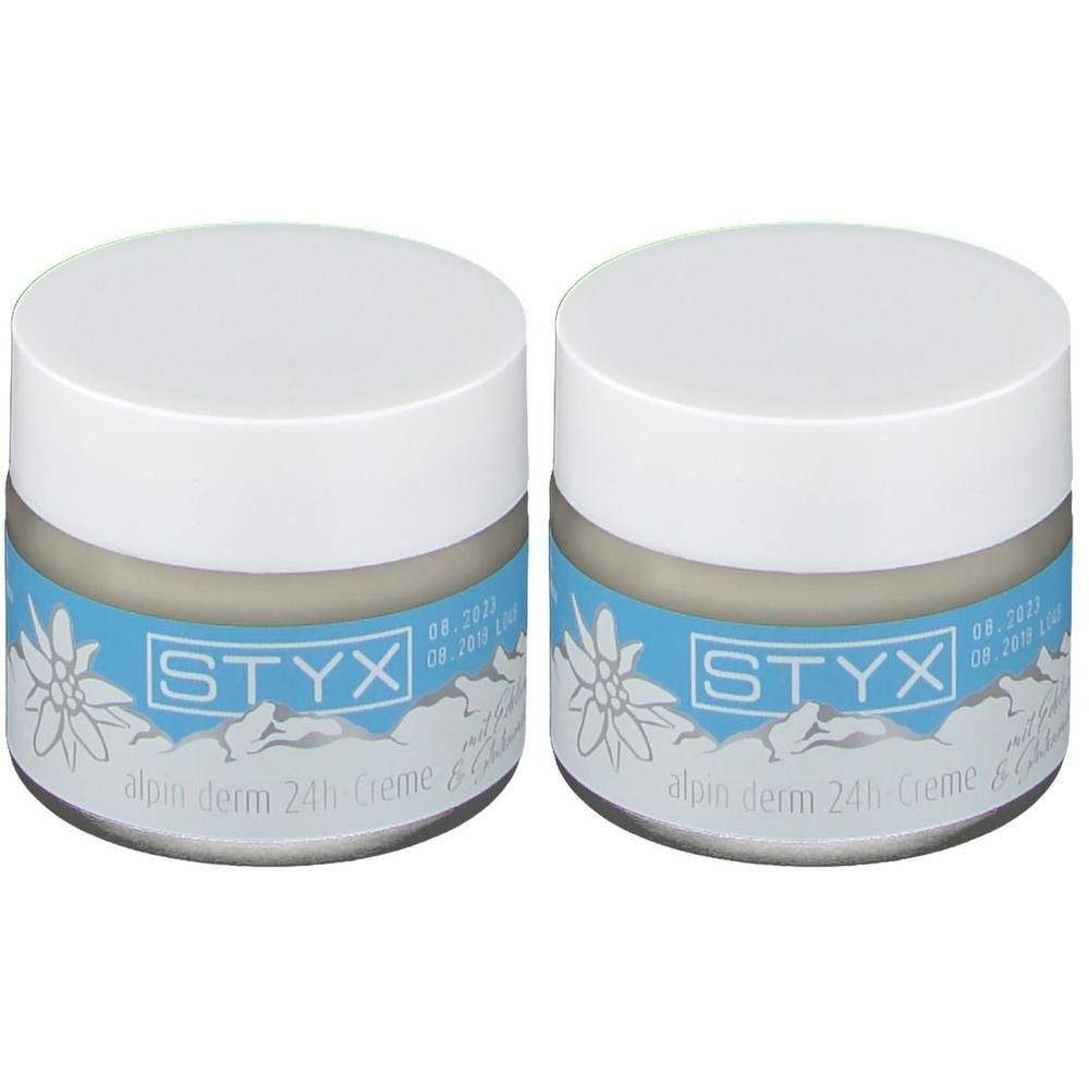 Zwei STYX alpin derm 24h Cremetiegel mit Edelweiß-Motiv und Berglandschaft.