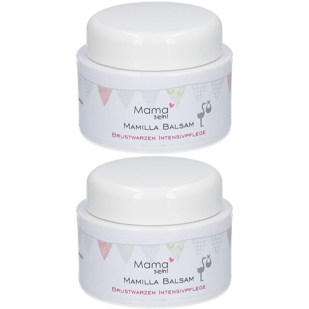 Zwei weiße Tiegel mit Deckel. Aufschrift: Mama semi Mamilla Balsam Brustwarzen Intensivpflege. Rosa und gelbe Girlanden.