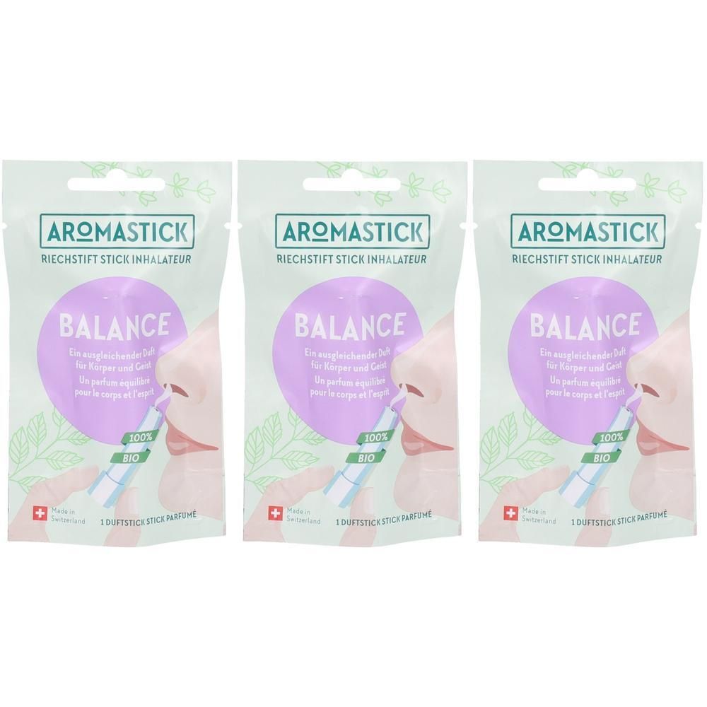Drei AromaStick Balance Riechstifte in Verpackung. Grün-weiße Verpackung mit lila Kreis und Nasen-Illustration. Text: AromaStick, Balance, 100% Bio.
