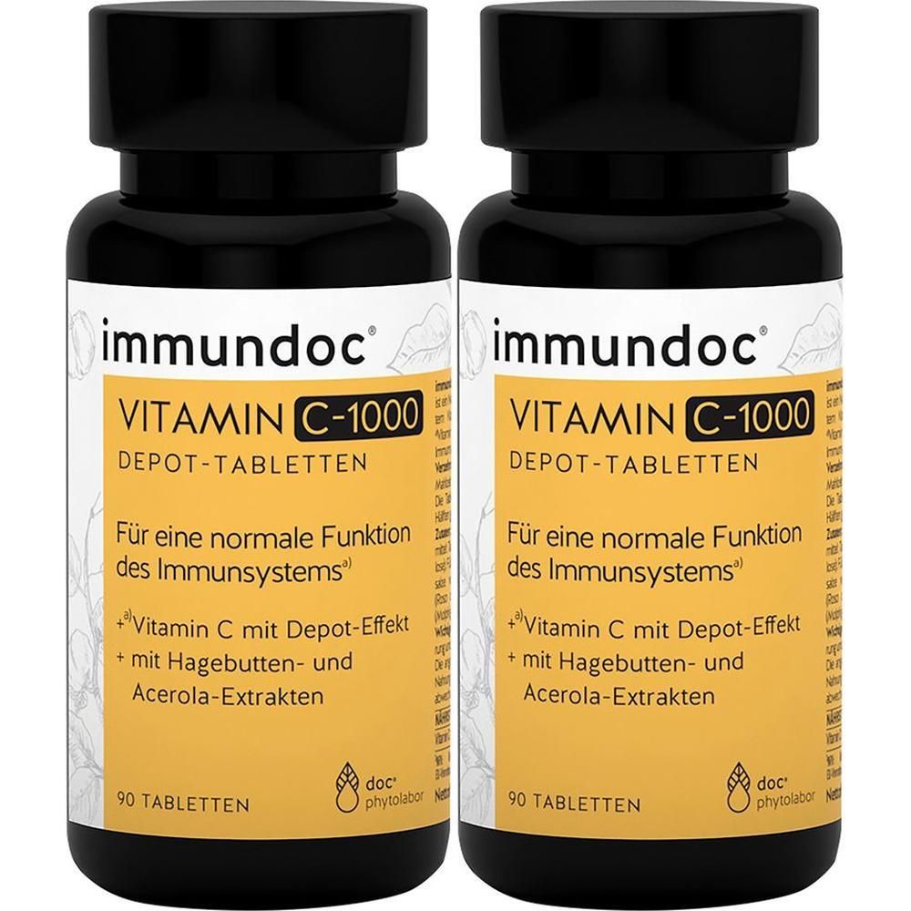Zwei Flaschen immundoc Vitamin C-1000 Depot-Tabletten. Schwarze Deckel, gelbe Etiketten mit Produktinformationen. 90 Tabletten pro Flasche.