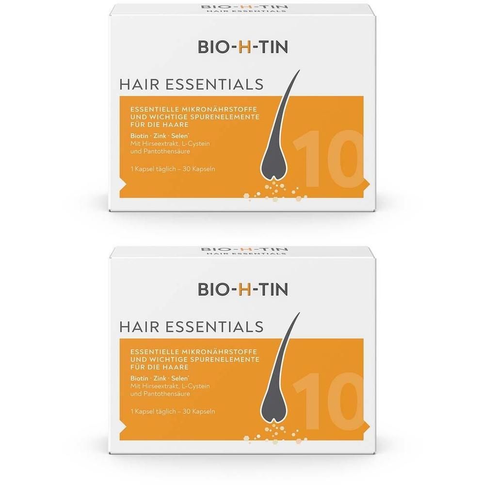 Zwei Packungen BIO-H-TIN Hair Essentials. Weiße Schachteln mit orangefarbenem Feld und Produktinformationen. Aufdruck: Haarsträhne, 10 Kapseln.