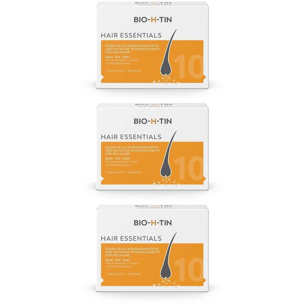 Drei Schachteln BIO-H-TIN® Hair Essentials. Weiße Verpackung mit orangefarbenem Streifen und Produktnamen. Abbildung eines Haares.