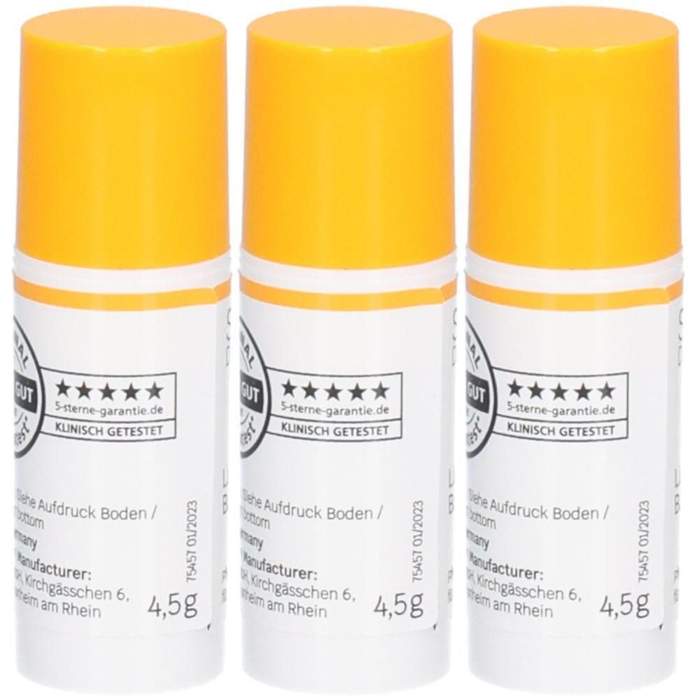 Drei Lippenbalsam-Stifte mit orangen Kappen und weißen Etiketten, jeweils 4,5g. "Klinisch getestet" Siegel sichtbar.