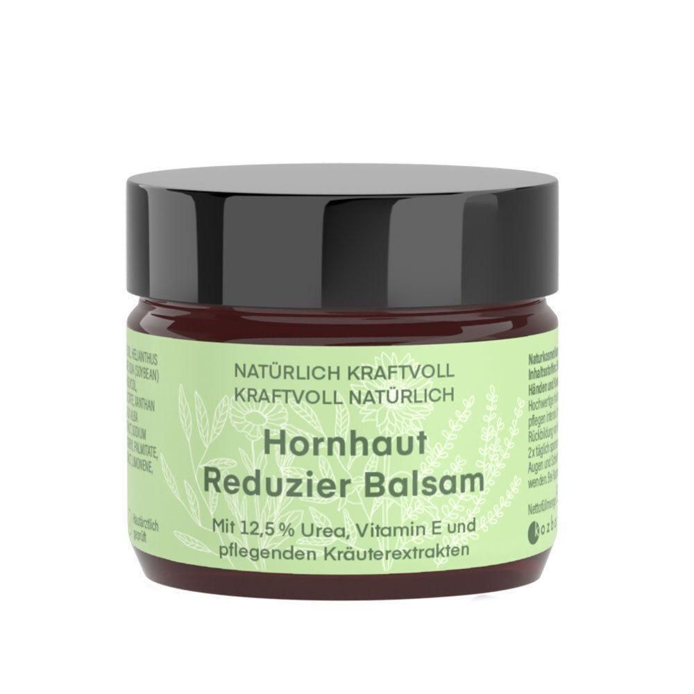 Rundes Glas mit schwarzem Deckel. Aufschrift: Hornhaut Reduzier Balsam. Enthält 12,5% Urea, Vitamin E und Kräuterextrakte.