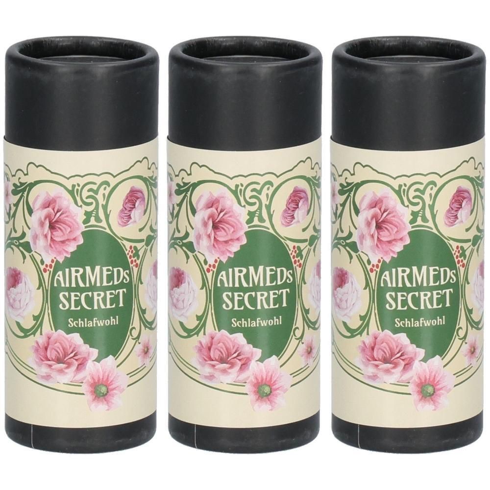 Drei zylindrische Behälter mit schwarzem Deckel. Aufdruck: Airmeds Secret Schlafwohl, floralem Muster mit rosa Blüten.
