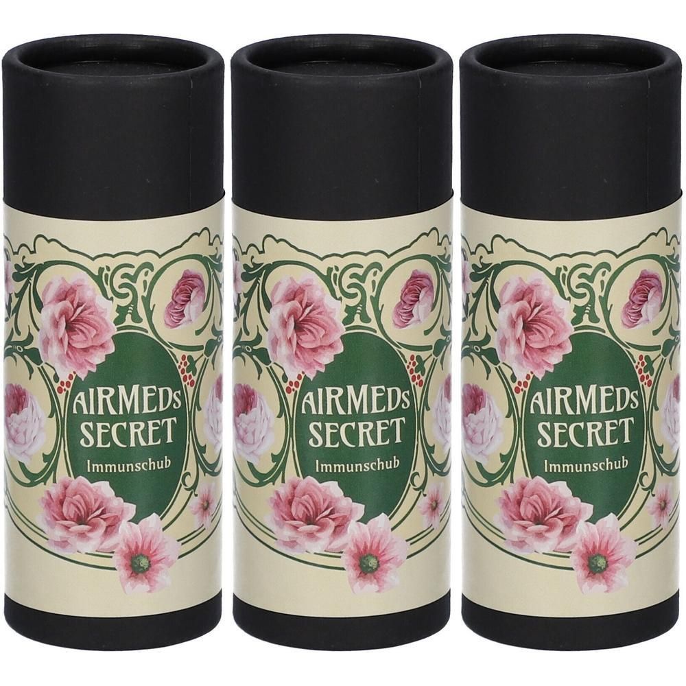 Drei zylindrische Behälter mit schwarzem Deckel. Aufschrift: AIRMEDS SECRET Immundschub, floralem Design mit rosa Blüten.