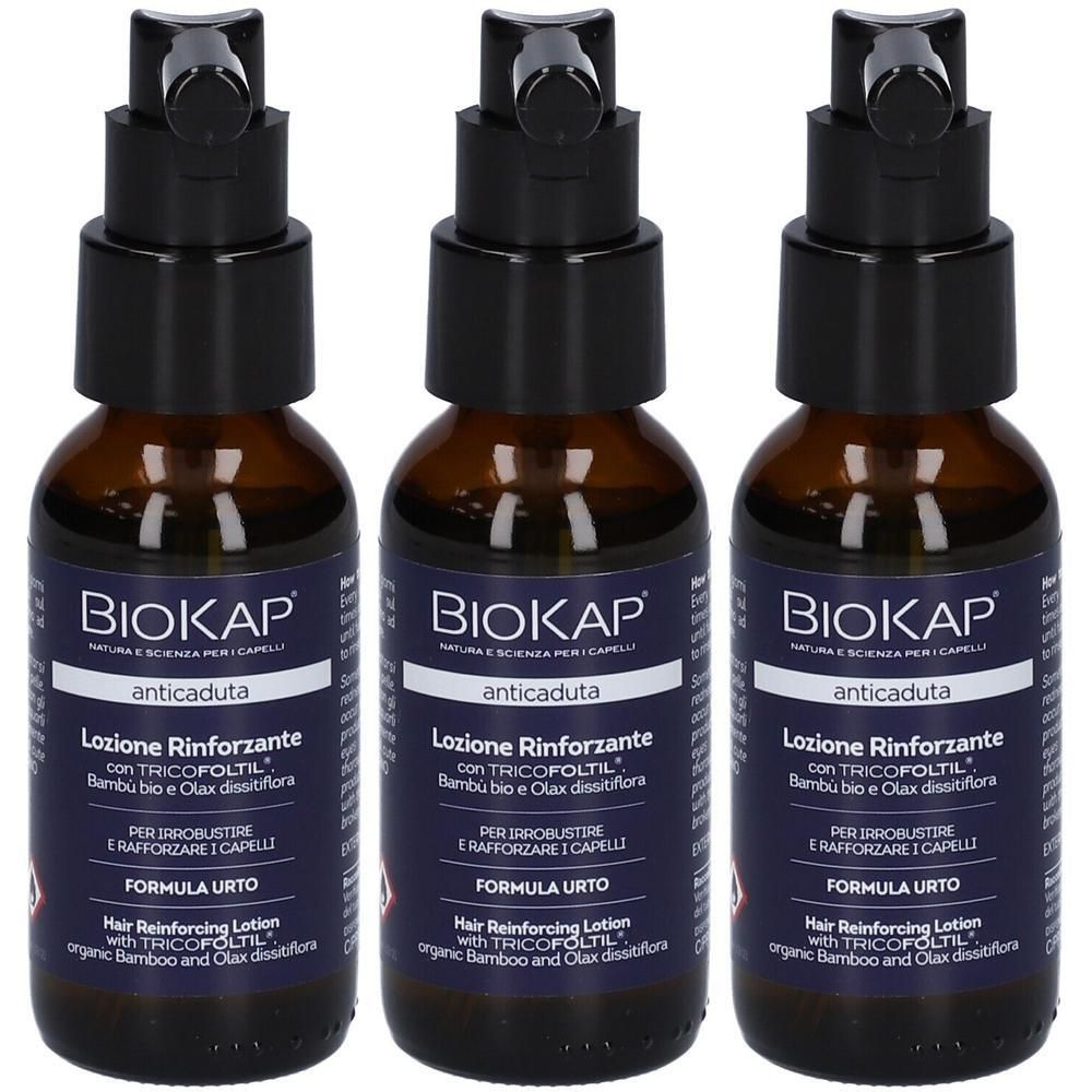 Drei Flaschen mit schwarzem Verschluss und braunem Glas. Aufschrift: BioKap, Lozione Rinforzante, anticaduta.