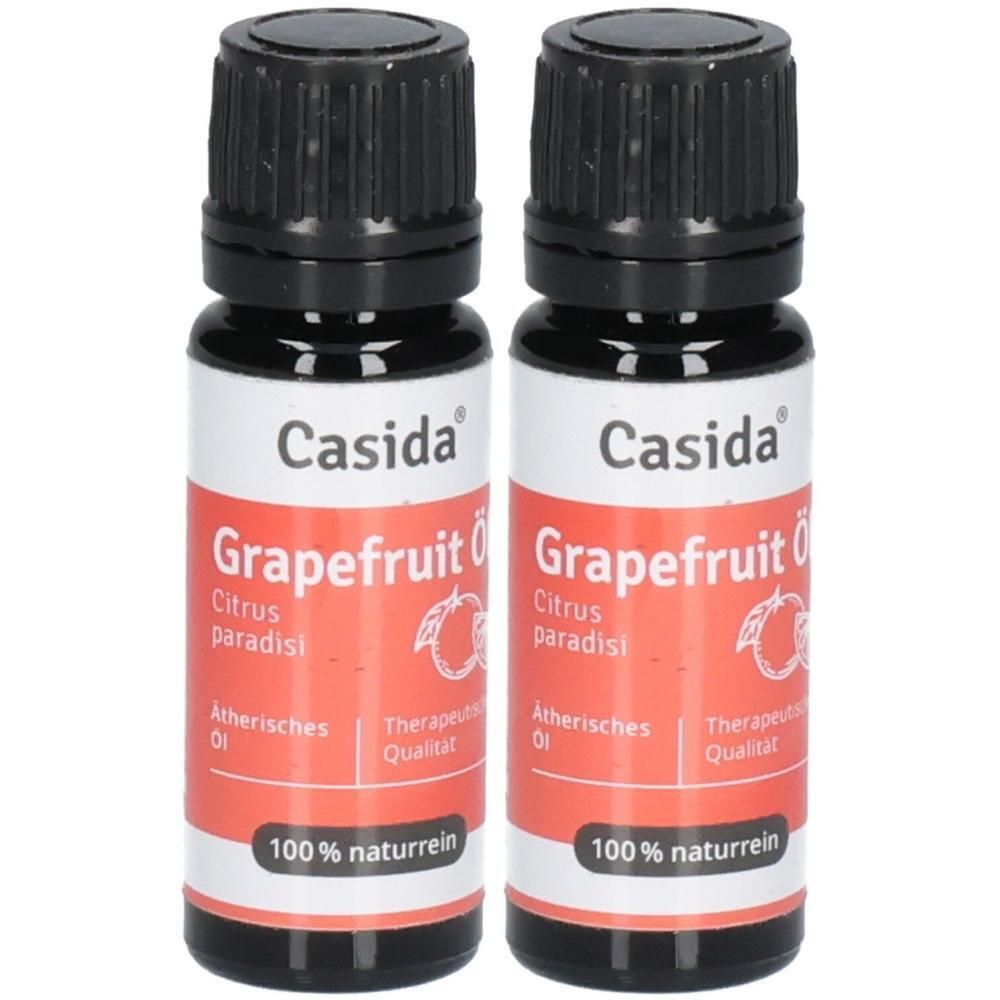 Zwei Flaschen mit schwarzem Deckel und weiß-rotem Etikett. Aufschrift: Casida Grapefruit Öl, 100% naturrein.