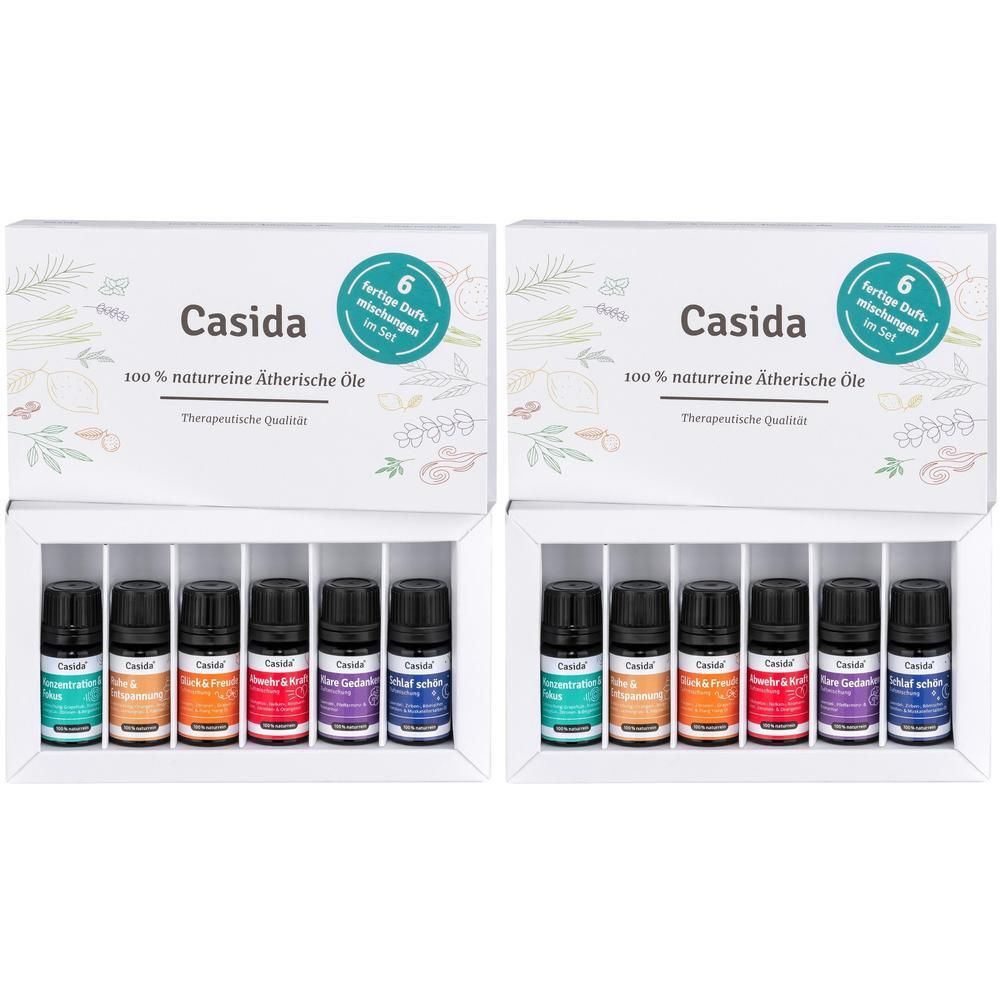 Zwei Casida® Ätherische Öle Sets. Jedes Set enthält sechs kleine Flaschen in einer weißen Schachtel. Aufschrift: 100% naturreine ätherische Öle.