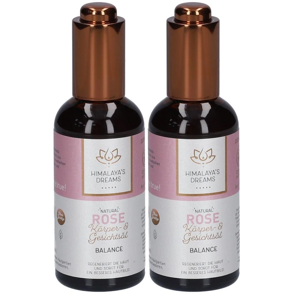 Zwei Flaschen Körper- und Gesichtsöl. Aufschrift: Himalaya's Dreams, Rose. Braune Kappe, rosa Etikett, schwarze Schrift.