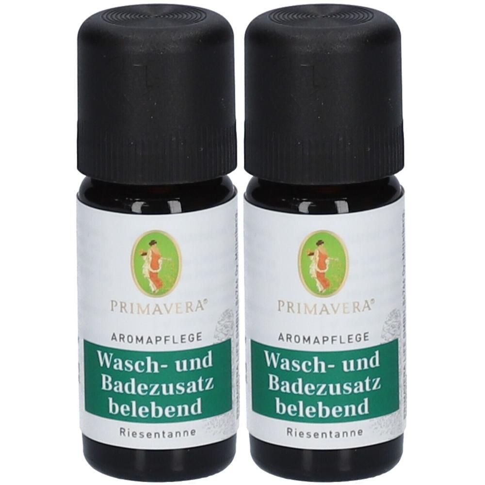 Zwei PRIMAVERA® Wasch- und Badezusatz belebend Fläschchen mit schwarzen Kappen. Etikett mit grüner Schrift.