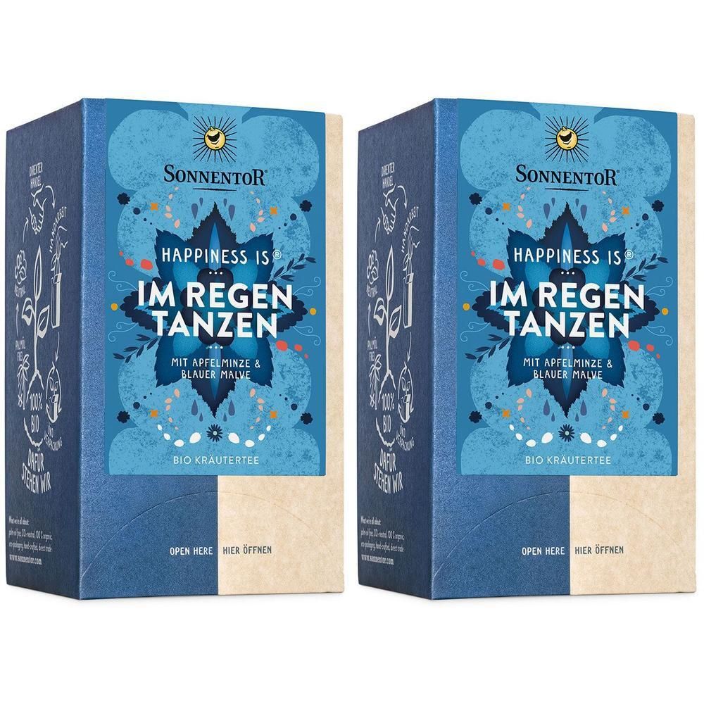Zwei blaue Kartons mit Aufschrift "HAPPINESS IS IM REGEN TANZEN". Marke: SonnentoR. Bio-Kräutertee. Text: Mit Apfelminze & blauer Malve.