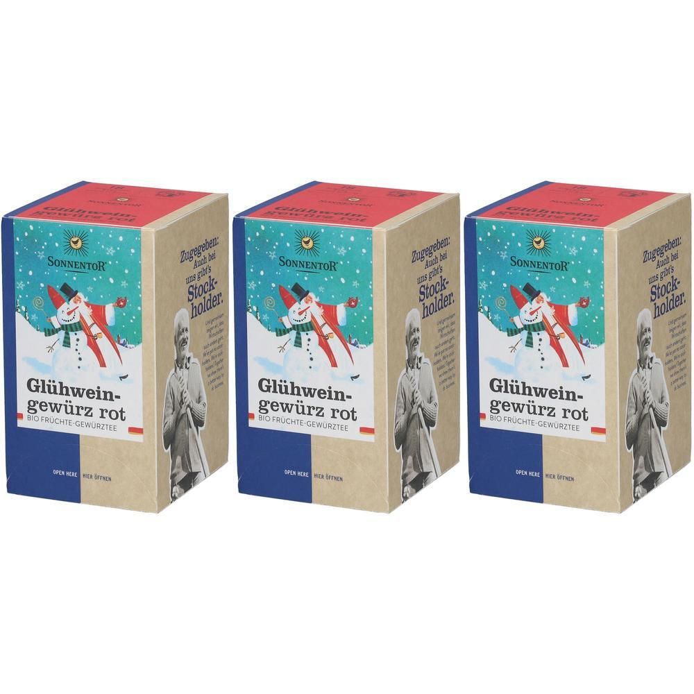 Drei Kartons mit Glühweingewürz rot. Aufdruck: Schneemann, Frau mit Stock, Schriftzug. Marke: Sonnentor. Verpackung mit rotem Deckel und blauem Boden.