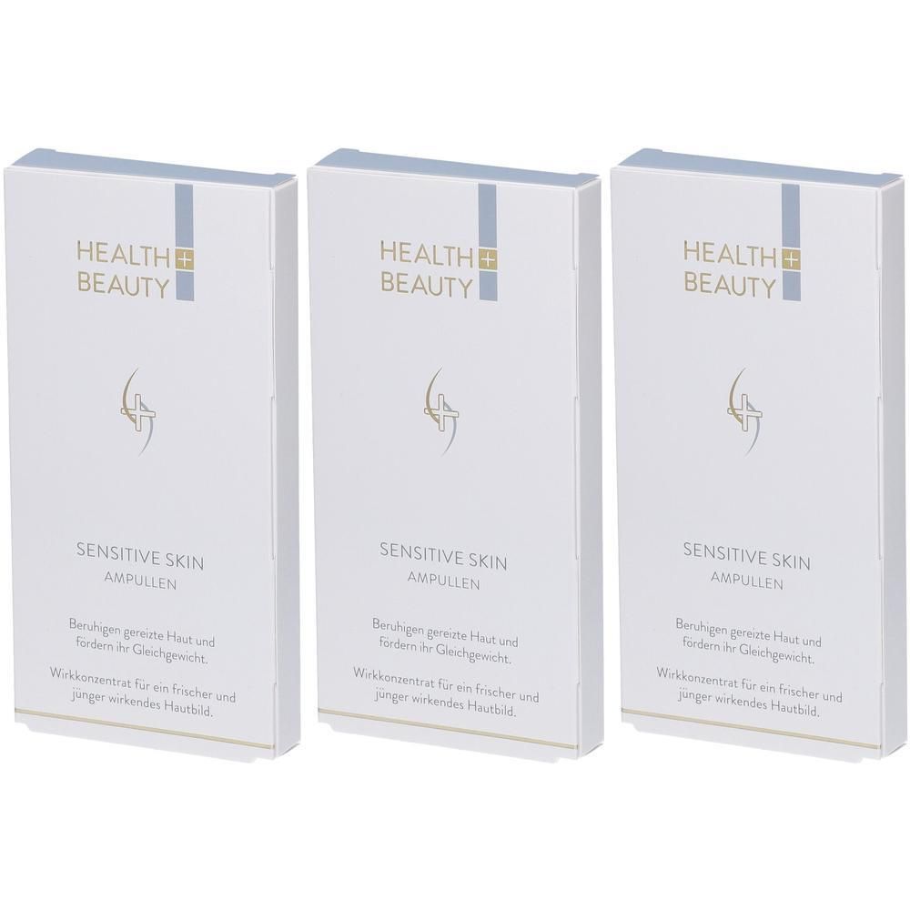 Drei weiße Kartons mit Produktinformationen. Aufschrift: HEALTH + BEAUTY, SENSITIVE SKIN AMPULLEN. Blaue und goldfarbene Akzente.