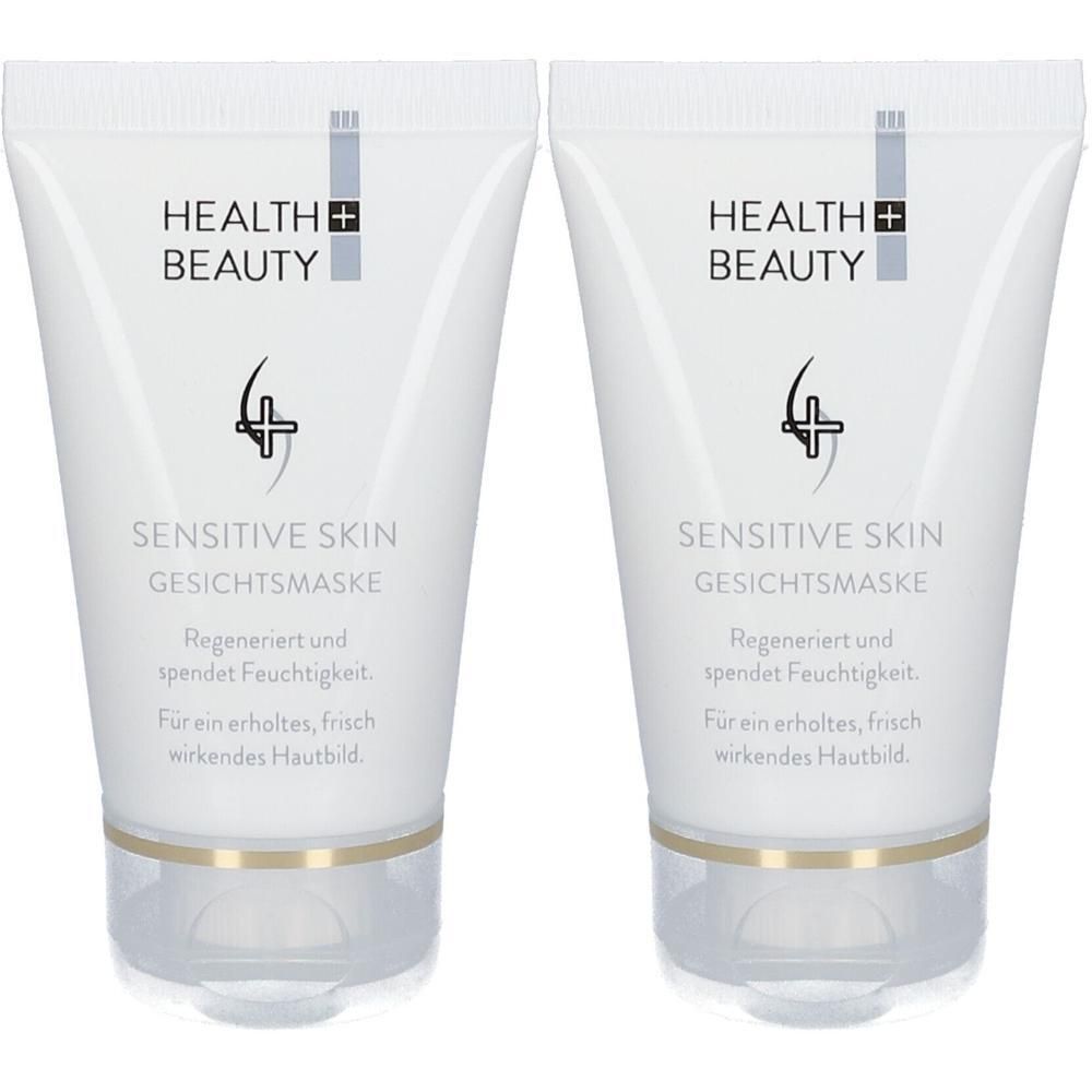 Zwei Tuben Gesichtsmaske. Weiße Tuben mit Aufschrift HEALTH + BEAUTY und SENSITIVE SKIN GESICHTSMASKE. Goldfarbener Ring am Boden.