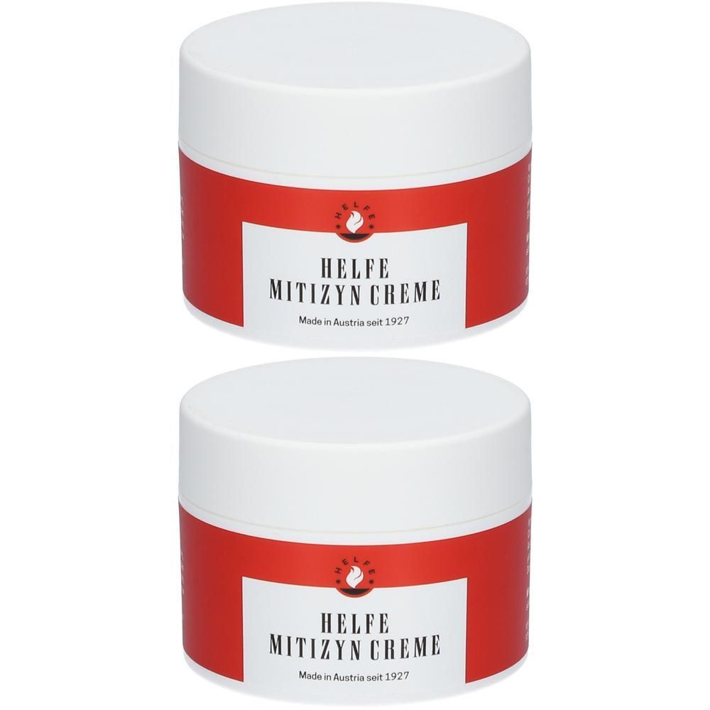 Zwei weiße Tiegel mit rotem Etikett, auf dem HELFE MITIZYN CREME steht.