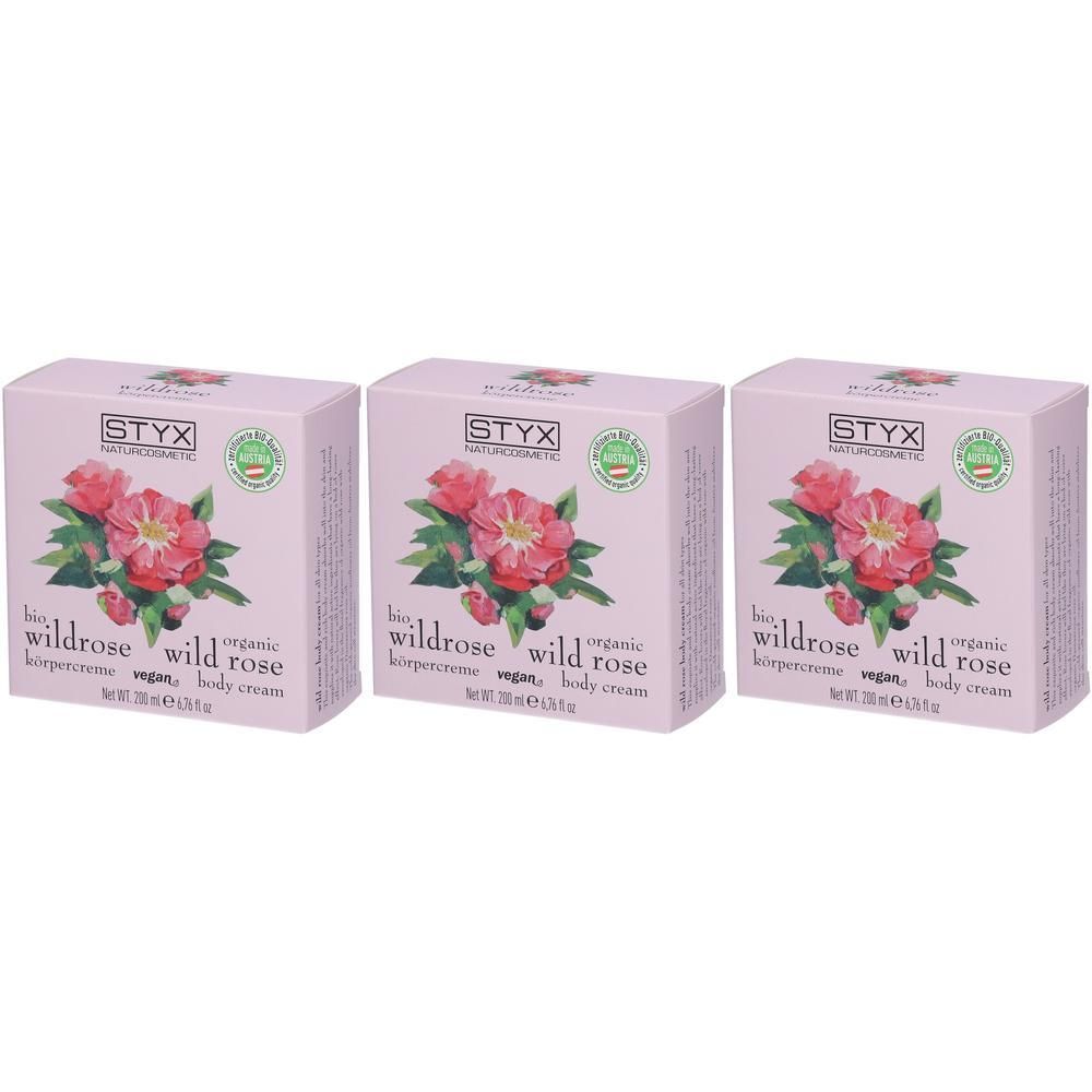 Drei Schachteln STYX Bio Wildrose Körpercreme mit Rosenmotiv.