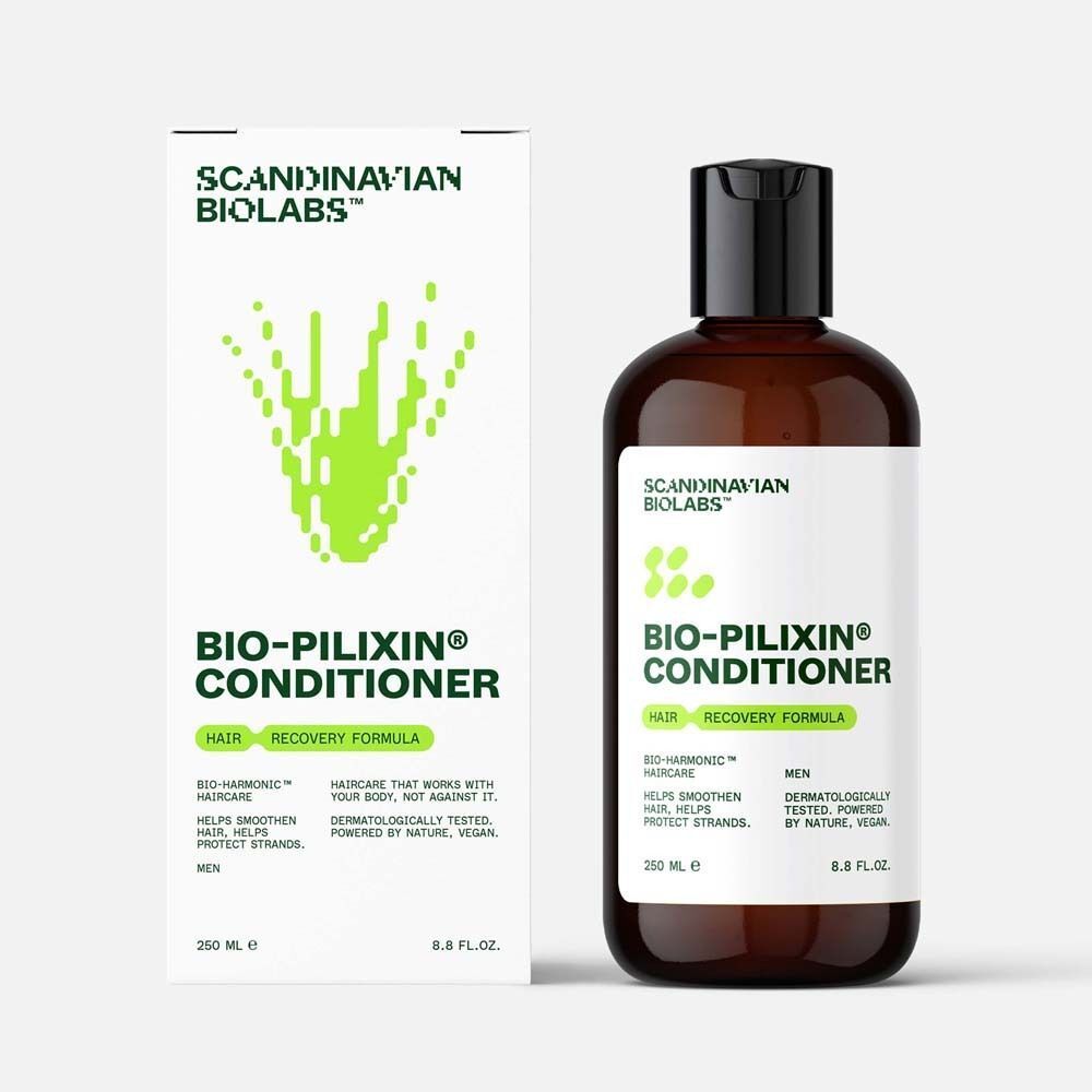 Bio-Pilixin Conditioner Flasche neben Verpackung. Braune Flasche mit schwarzem Deckel. Verpackung weiß mit grünem Logo und Text.